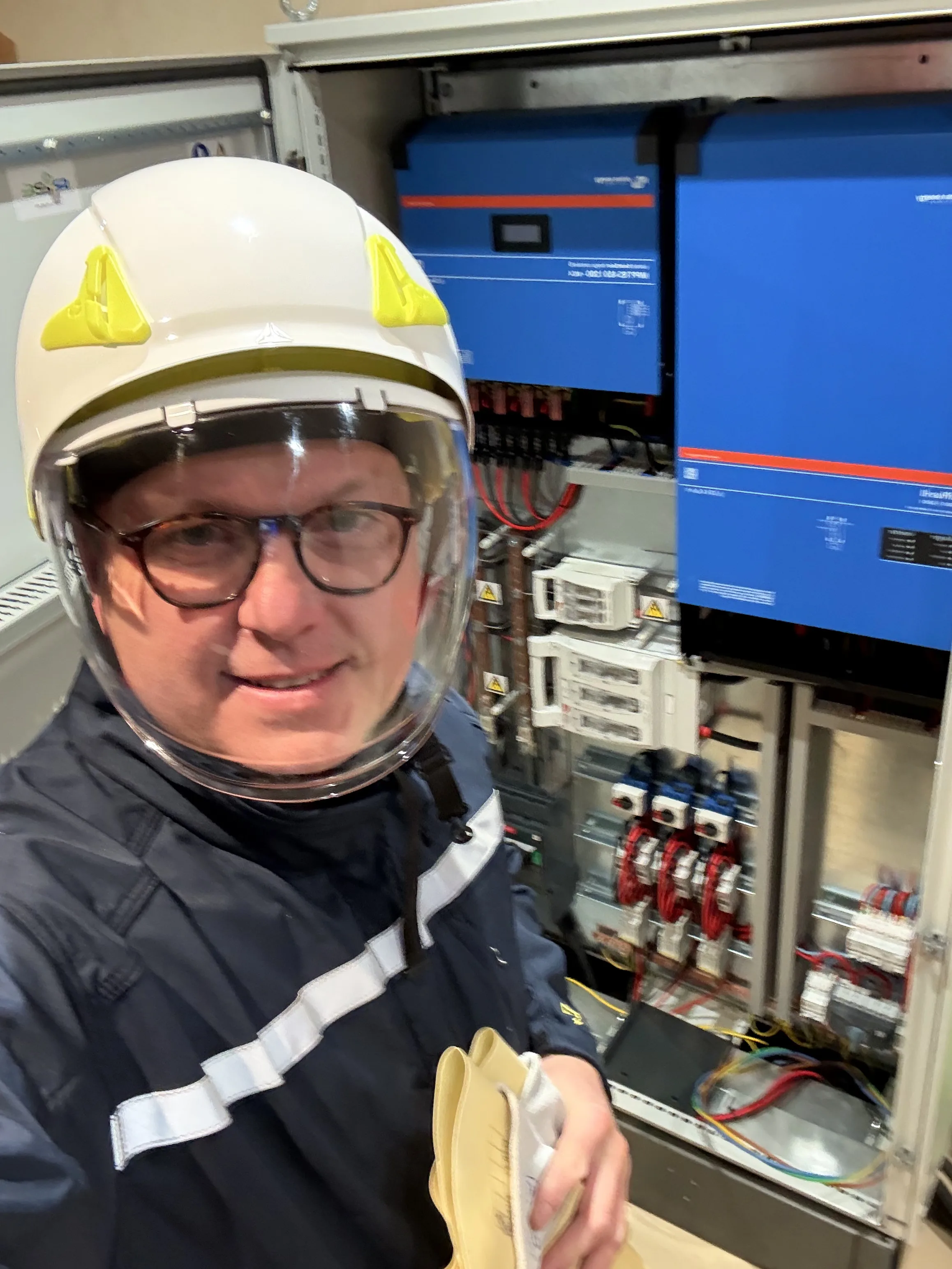Technicien devant un onduleur solaire, prêt pour la maintenance photovoltaïque